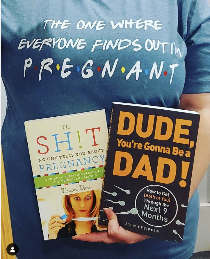 woman in friends style t-shirt with pregnancy books 