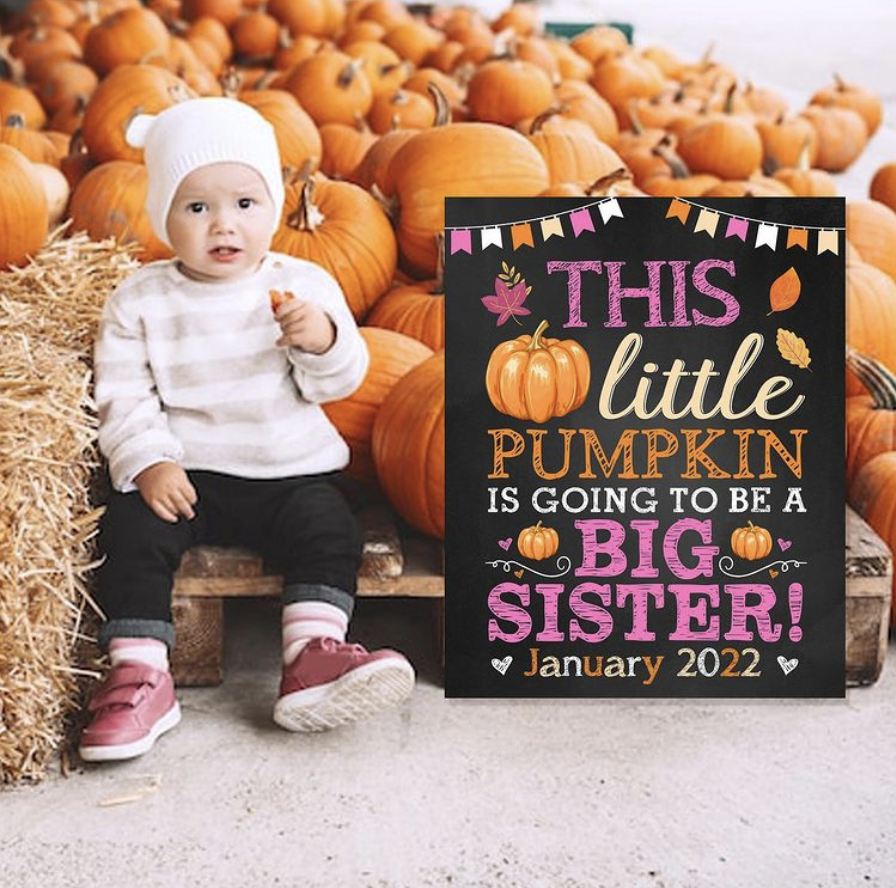 little girl in pumpkin patch pregnancy announcement 