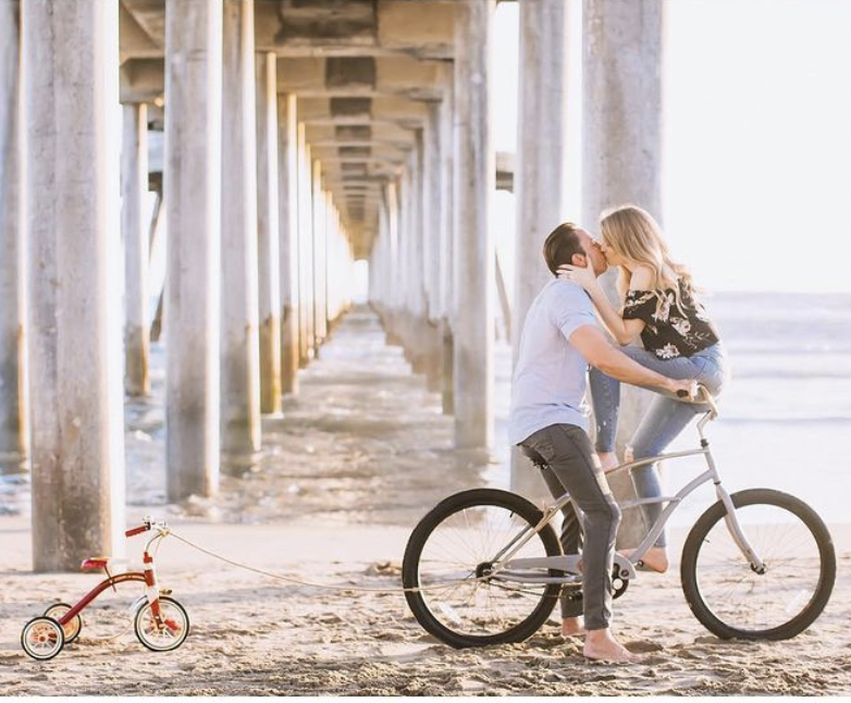 couple with bike and trike in pregnancy announcement 
