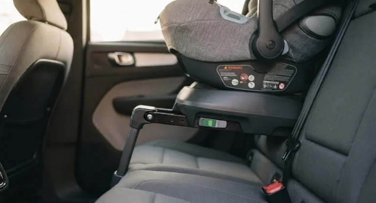 ISOFIX base securing a baby car seat in a car's rear seat